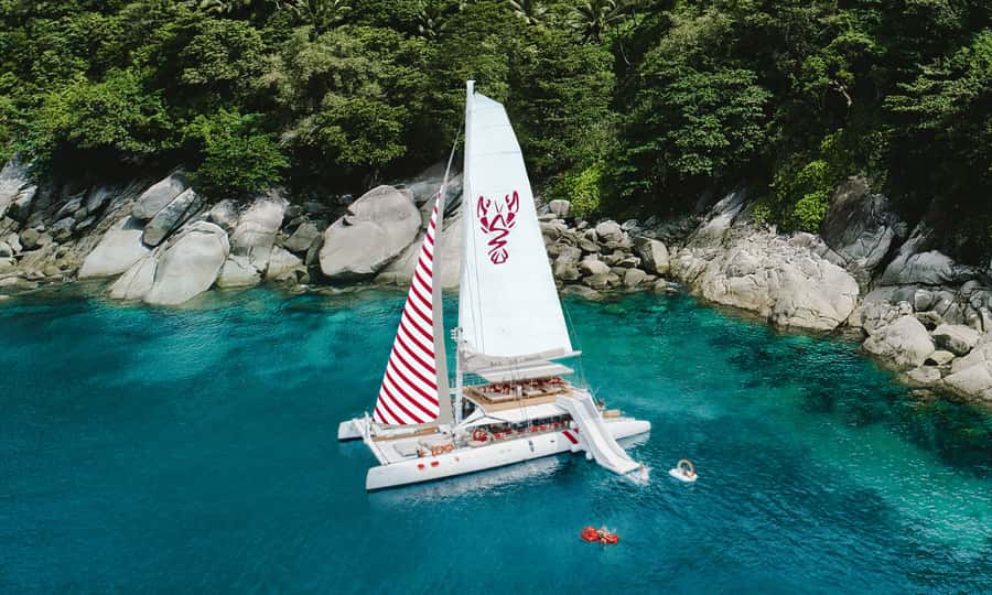 Phuket: Sailing Yacht Island Hopping & Party Full-Day Cruise - Coral Island (Banana Beach): first swim, Thai buffet lunch, and beach chairs